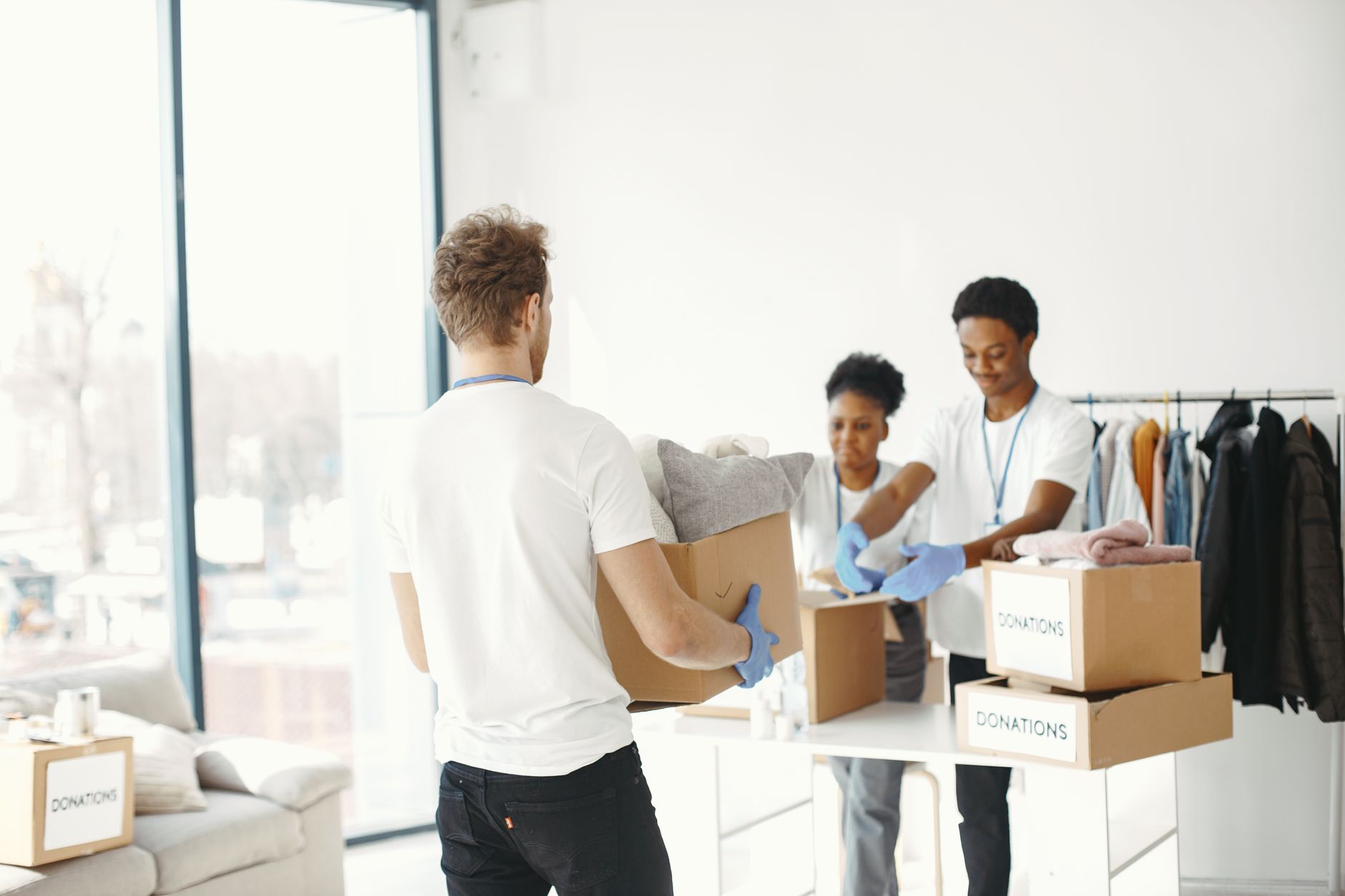 man in white t shirt carrying a box